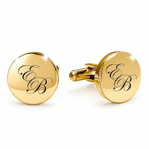 May include: A pair of round, polished gold-tone cufflinks featuring a smooth, reflective surface. Each cufflink is engraved with the elegant, interconnected cursive letters EB in black, centered on the circular face with a standard metal toggle back.