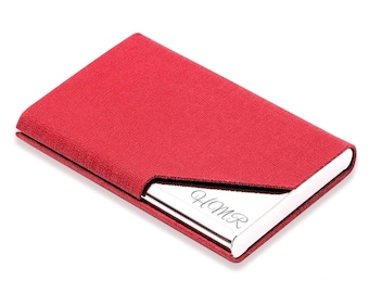 May include: Red leather business card holder with a silver metal insert. The insert has the name "HOMER" engraved on it.
