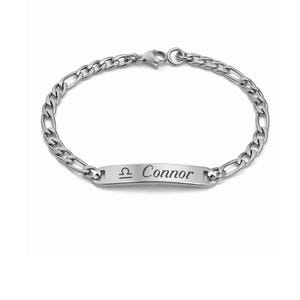 May include: A silver-colored bracelet with a chain link design. The bracelet features a rectangular plate engraved with the name "Connor" and the Libra zodiac symbol. The bracelet is shown against a white background.