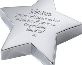 May include: A polished silver star-shaped keepsake with engraved text. The inscription reads "Sebastian, Give the world the best you have, and the best will come to you. Congratulations Mom & Dad 2021."