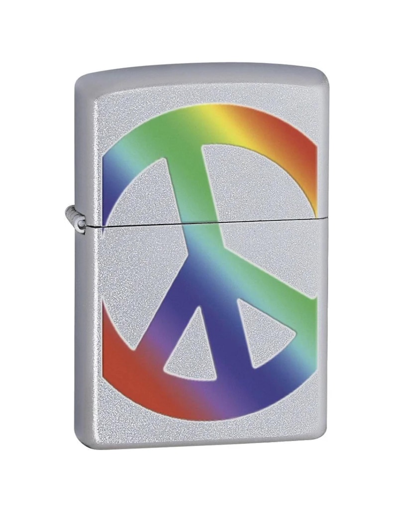 May include: Silver-colored lighter with a rainbow peace sign design. The peace symbol is rendered in a gradient of colors, including red, orange, yellow, green, blue, and purple. The lighter has a textured, metallic finish.