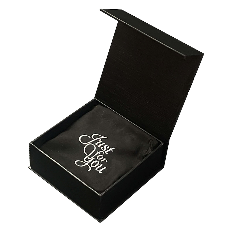 May include: A black gift box with the lid open, revealing a black fabric pouch inside. The pouch has the words "Just for You" in white script. The box has a glossy finish.
