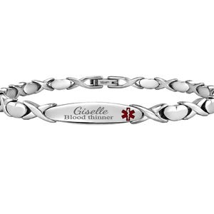 May include: A silver-toned medical alert bracelet featuring a series of alternating X-shaped and heart-shaped links. The central oval plate is engraved with the name Giselle, the text Blood thinner, and a red medical caduceus symbol.