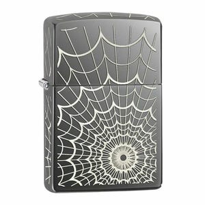 May include: A black lighter with a spider web design. The lighter has a rectangular shape with rounded edges and a silver hinge. The spider web design is etched in white across the front and sides of the lighter.
