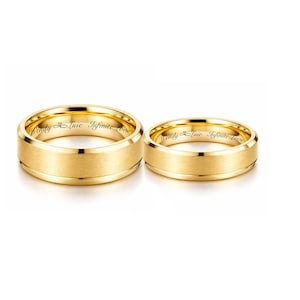 May include: Two gold wedding bands with a brushed finish. The rings have the inscription "Wendy & Luic Infinite Love" engraved on the inside. The rings are displayed on a white background.