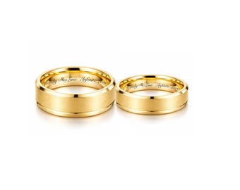 May include: Two gold wedding bands with a brushed finish. The rings have the inscription "Wendy & Luic Infinite Love" engraved on the inside. The rings are displayed on a white background.