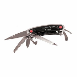 May include: A black multi-tool pocket knife with a silver blade and red accents. The handle is engraved with the text "I Love You Dad".