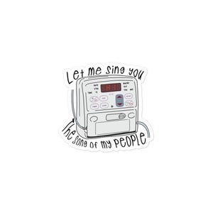 May include: A white sticker featuring a medical device with a digital display and buttons. The sticker has the text "Let me sing you the song of my people" in a handwritten style font.
