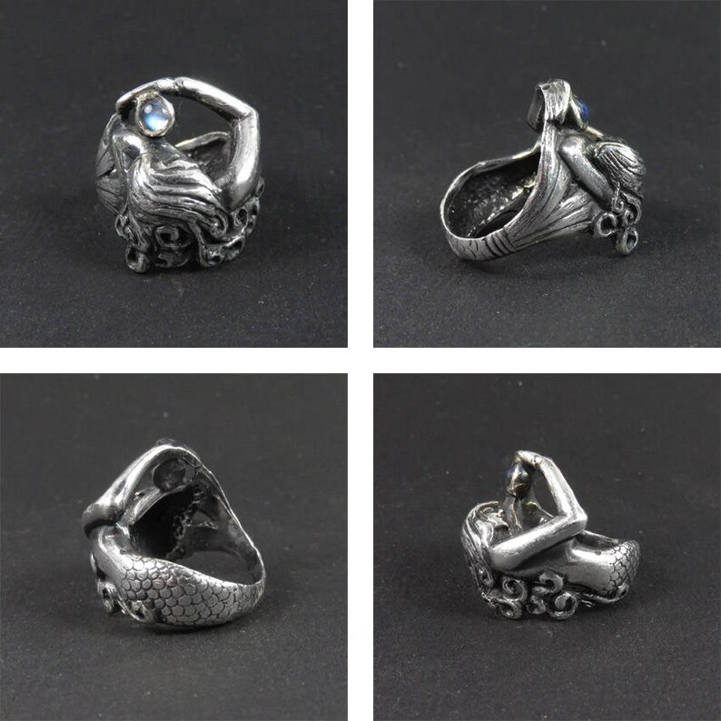 May include: A silver ring featuring a detailed mermaid design holding a pearl. The ring is shown from multiple angles.