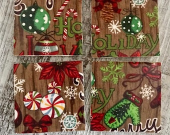 May include: Four square coasters with a wood grain background and festive holiday designs. Each coaster features a different design, including ornaments, candy canes, snowflakes, and the words "Holiday" and "Merry". The coasters are square.