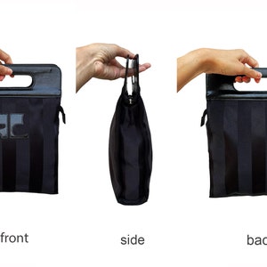 May include: Black tote bag with vertical stripes and a rectangular handle. The bag features a leather handle and a logo on the front. The side view shows the bag's shape, while the front and back views display the striped pattern.