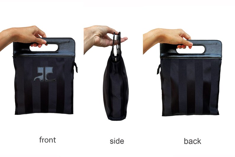 May include: Black tote bag with vertical stripes and a rectangular handle. The bag features a leather handle and a logo on the front. The side view shows the bag's shape, while the front and back views display the striped pattern.