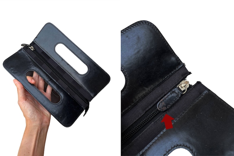 May include: Black leather clutch with two rectangular cut-out handles. The clutch has a zipper closure and a silver-toned zipper pull. The leather appears to be slightly worn. The clutch is held open, displaying the interior.