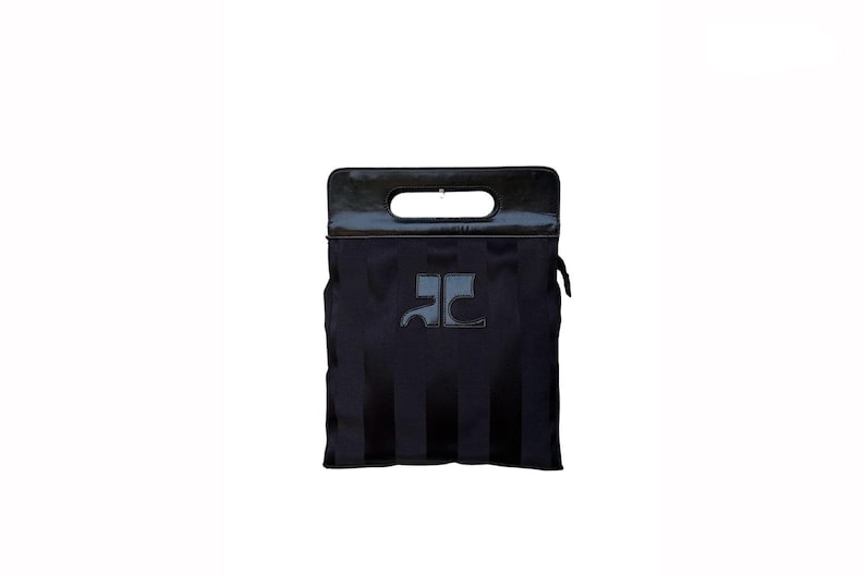 May include: Black tote bag with a glossy black handle and a rectangular opening. The bag features a dark gray logo and vertical stripes. The bag has a zipper on the side.