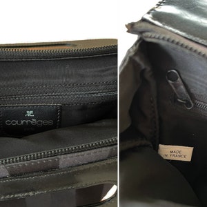 May include: Black Courr&egrave;ges handbag with a zipper closure. The interior features a black lining and a leather tag with the brand name. The bag is marked "Made in France".