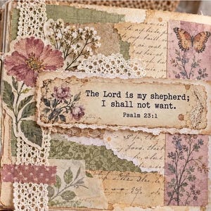 May include: A scrapbook page featuring layered paper, lace trim, and floral cutouts. The central text reads, The Lord is my shepherd; I shall not want. Psalm 23:1. The design includes a butterfly illustration, vintage-style script, and muted earth tones.