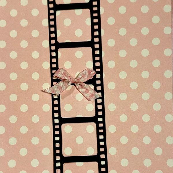 Film strip die cut for  scrapbooking pages or paper crafting ideas you have . Place a small photo behind each square .Bow for suggestion .