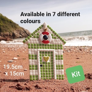 May include: A mosaic beach hut kit, with green and white tiles, a red and white life preserver, and a yellow heart. The hut measures 19.5cm x 15cm and is available in 7 colours. The word "Kit" is displayed on a green square.