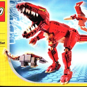 May include: LEGO Designer Set 4507, a building set for ages 7 and up, features three dinosaurs: a red Tyrannosaurus Rex, a gray Ankylosaurus, and a red Pterodactyl.