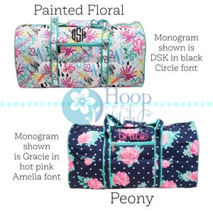 May include: Two duffel bags with floral patterns. The top bag has a painted floral design with a black monogram. The bottom bag features a navy blue background with pink peony flowers and the name "Gracie" embroidered in pink.
