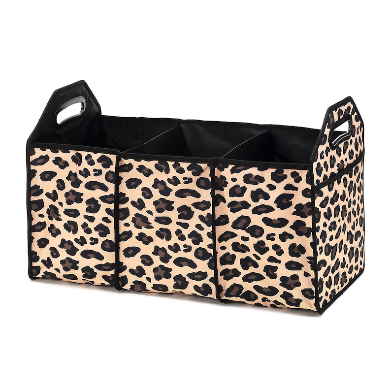 May include: A black and tan leopard print fabric storage organizer with three compartments and a handle. The organizer is designed to fit in the back of a car.
