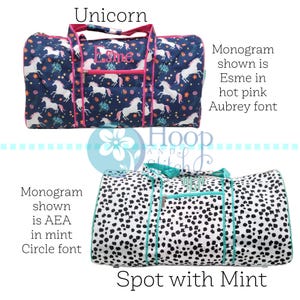 May include: Two duffel bags. The top bag is navy blue with a unicorn pattern and pink trim. The bottom bag is white with black spots and mint green trim. The top bag has the name "Esme" embroidered on it.
