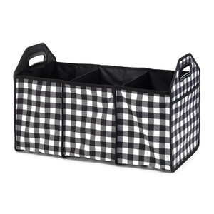 May include: Black and white checkered fabric storage organizer with three compartments and two handles. The organizer is designed for use in a car.