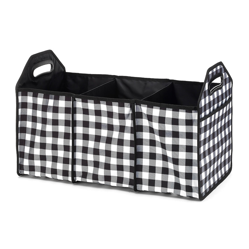 May include: Black and white checkered fabric storage organizer with three compartments and two handles. The organizer is designed for use in a car.