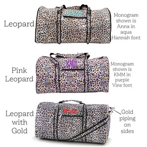 May include: Three duffel bags with leopard print patterns. One is classic leopard print with aqua embroidery, another is pink leopard print with purple embroidery, and the third is leopard print with gold piping and red embroidery.