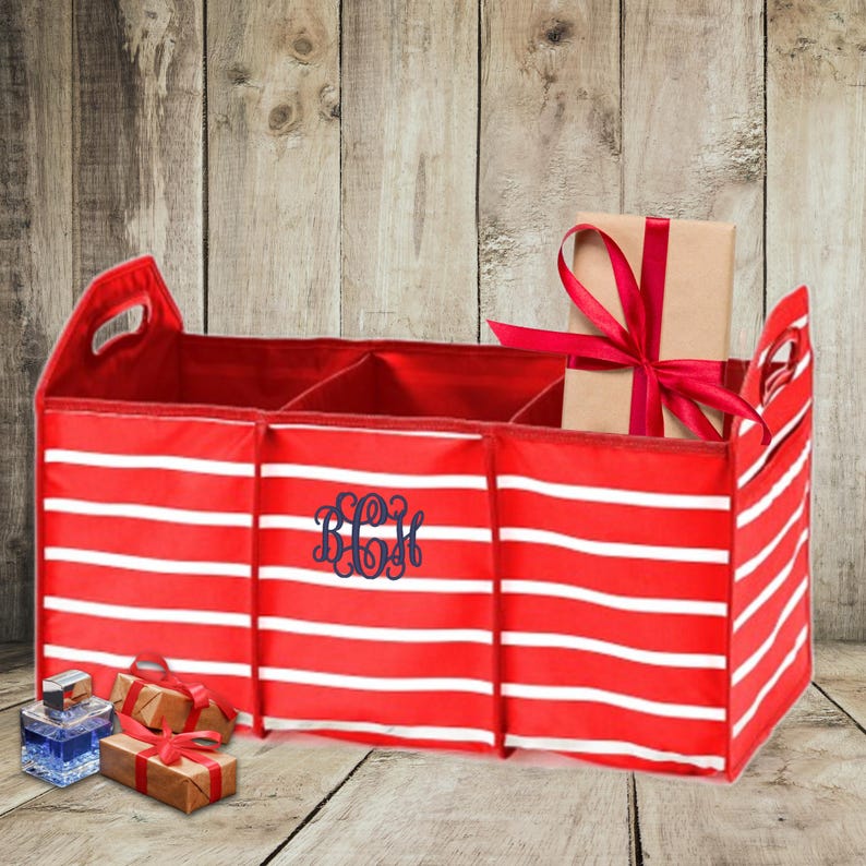 May include: Red and white striped fabric storage bin with three compartments and a handle. The bin has a monogram "BCH" embroidered on the front.