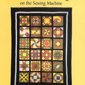 May include: Book cover with a yellow background and the title "Making an Old-Fashioned Patchwork Sampler Quilt on the Sewing Machine". The cover features a black and white image of a quilt with 24 colorful patchwork squares.