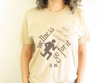 Vintage Wellness T shirt 1970s 1980s Tan Distressed Wellness Go For It 5K Running Souvenir Screen Stars T shirt M