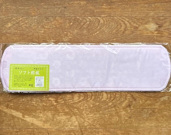 May include: A rectangular, light purple kimono obi board with a subtle, repeating floral pattern. The item is encased in clear plastic packaging and features a bright green rectangular label with Japanese text on the left side.