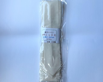 May include: A folded, cream-colored fabric sash or belt packaged in a clear plastic sleeve. A white paper label is wrapped around the center, featuring Japanese text, the measurement 270cm, and the specification of 100% wool material.