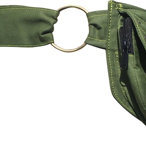 May include: Olive green fanny pack with a gold-colored metal ring and a black zipper. The pack has a quilted design and a strap for wearing around the waist. The fanny pack is made of a durable fabric.