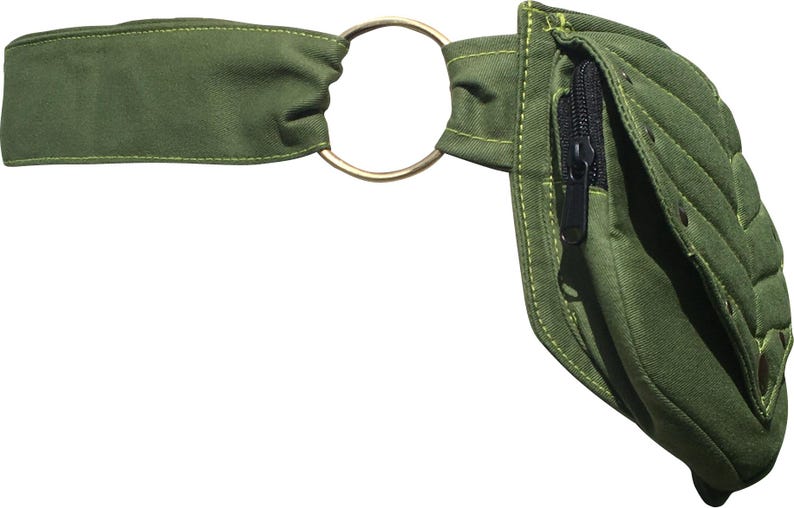 May include: Olive green fanny pack with a gold-colored metal ring and a black zipper. The pack has a quilted design and a strap for wearing around the waist. The fanny pack is made of a durable fabric.
