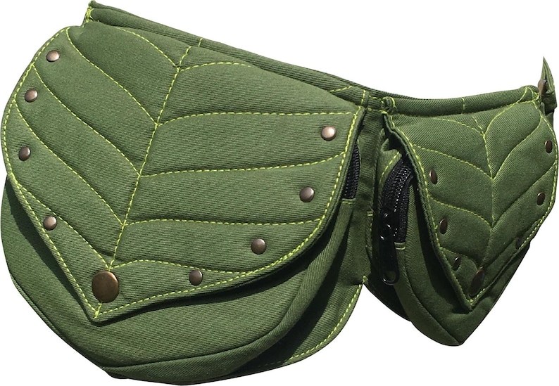 May include: Green leaf-shaped fanny pack with a quilted design and yellow stitching. The bag has multiple compartments, including zippered pockets and a snap closure. Bronze-colored rivets add detail to the bag's edges.