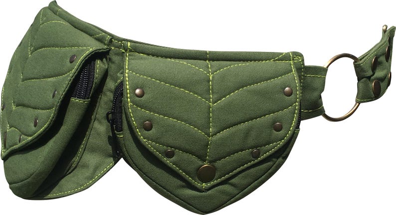May include: Olive green fanny pack with leaf-shaped pockets and decorative stitching. The pack features a zippered pocket, metal rivets, and a circular metal buckle. The belt is adjustable.