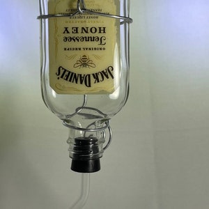 Jack Daniels Tennessee Honey Liquor bottle small hummingbird feeder. 100ml. Hand wire wrapped. Labels sealed with epoxy resin.