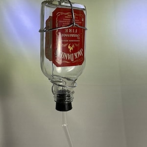 Jack Daniels Tennessee Fire Liquor bottle small hummingbird feeder. 100ml. Hand wire wrapped. Labels sealed with epoxy resin.