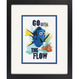 May include: A framed cross-stitch design featuring Dory from Finding Nemo. The design includes Dory swimming with a yellow and orange fish. The text "Go with the Flow" is written in blue and white.