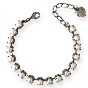 Adjustable crystal pearl tennis style bracelet set in antique silver.