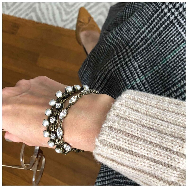 Vintage style pearl tennis bracelet shown in a stack.