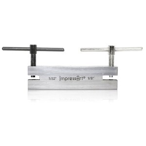 May include: A silver metal punch tool with two handles. The tool has two punch sizes, 5/32" and 1/8". The tool is labeled "ImpressArt".