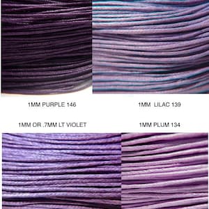 May include: A collection of 90 yards of waxed cotton cord in various purple shades. The image displays four distinct spools labeled 1MM PURPLE 146, 1MM LILAC 139, 1MM OR .7MM LT VIOLET, and 1MM PLUM 134, showcasing different purple hues.