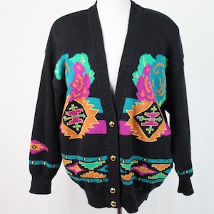 May include: Black cardigan sweater with a colorful southwestern pattern featuring roses, geometric shapes, and turquoise accents. The cardigan has a v-neck and button closure.