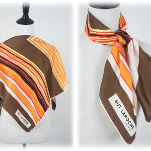 May include: A brown, orange, and white striped silk scarf with a white label that reads "GUY LAROCHE PARIS".