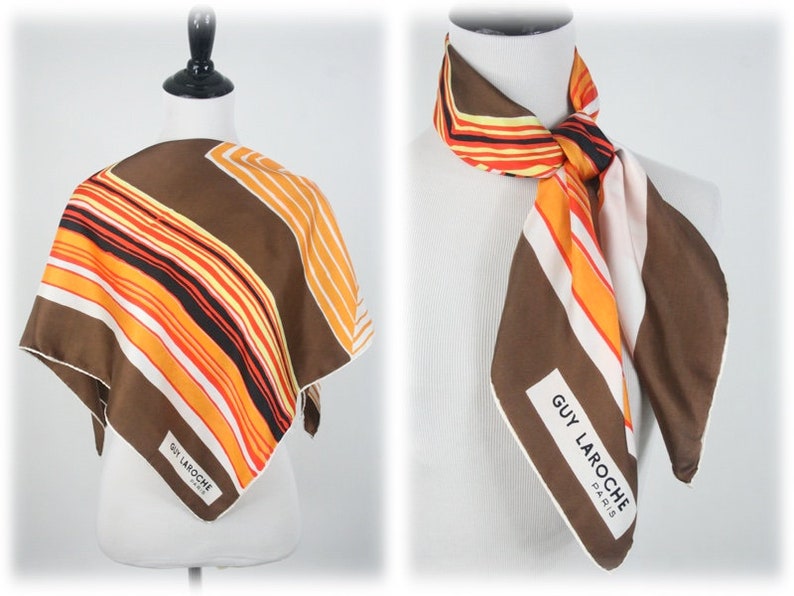 May include: A brown, orange, and white striped silk scarf with a white label that reads "GUY LAROCHE PARIS".