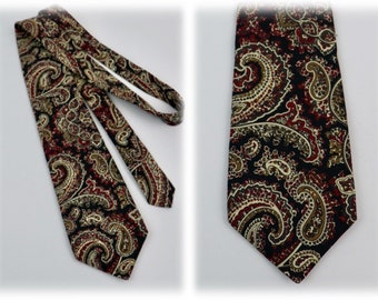 May include: A black paisley patterned tie with red, gold, and white accents.