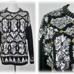 May include: A black sweater with silver and gold sequins in a geometric pattern.